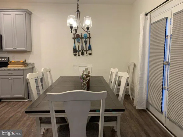 a view of a dining room with furniture wooden floor and chandelier