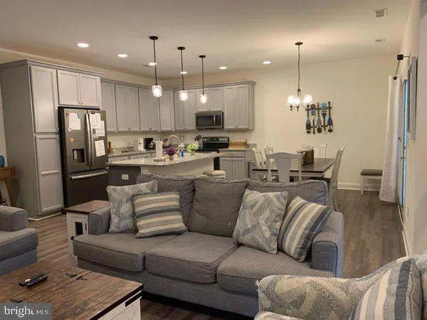 a view of a living room kitchen and a refrigerator