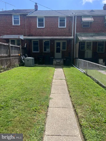 a view of a brick house with a yard