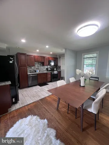 a large kitchen with a table and chairs