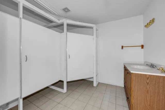 a view of a storage & utility room with a sink