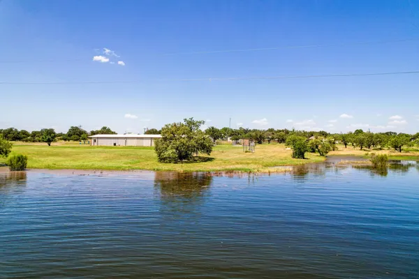 a view of an ocean with a building in the background