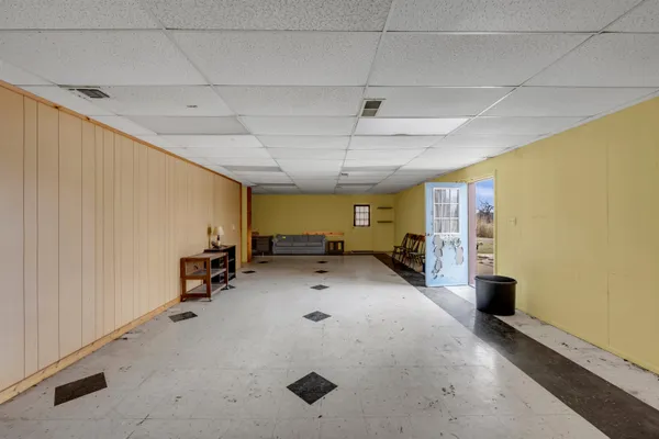 a view of a livingroom with furniture and a garage