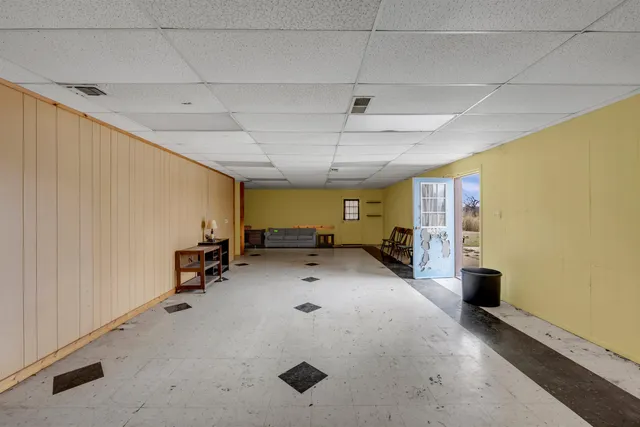 a view of a livingroom with furniture and a garage