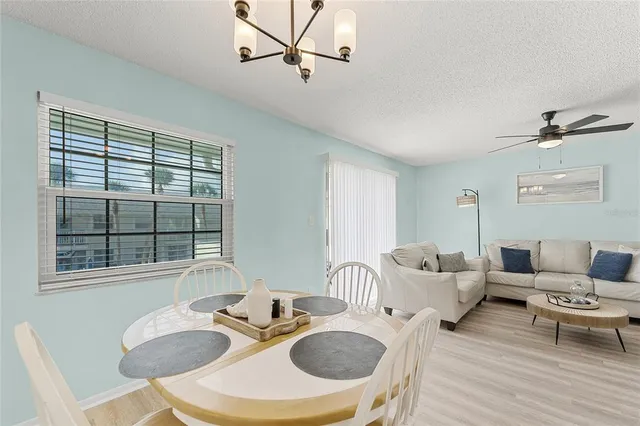 a kitchen with white cabinets and sink