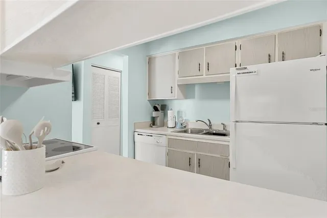 a kitchen with sink cabinets and toilet