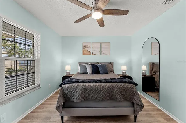 a bedroom with a bed and wooden floor