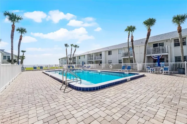 a view of a garden with lawn chairs