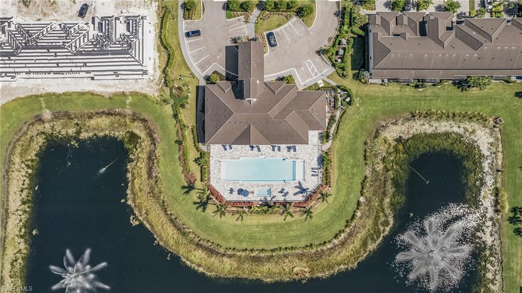 7596 Morgan Way Naples, FL 34119 - Photo 28 of 35 a view of a swimming pool with a yard