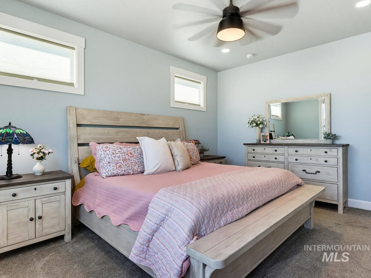 4950 West Columbia Road Nampa, ID 83687 - Photo 23 of 50 Bedroom featuring light blue walls, gray carpet, and white trim