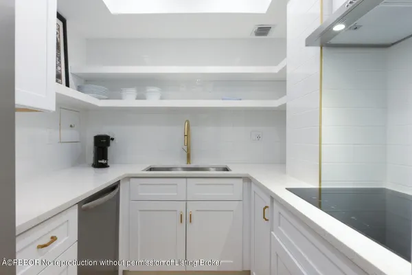 a kitchen with a sink and a stove