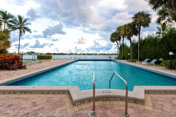 a view of swimming pool with a patio and a garden