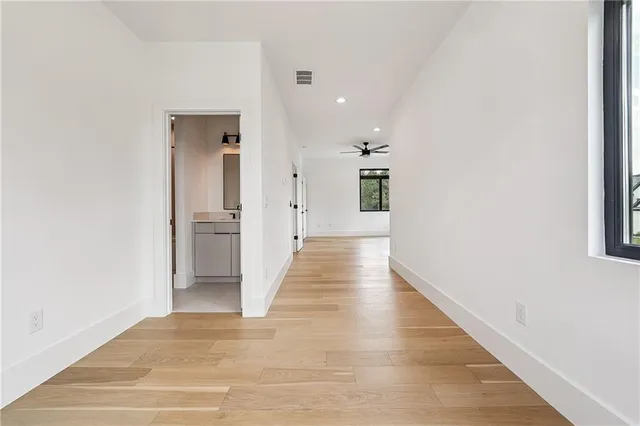 a view of a hallway with wooden floor