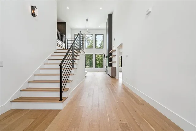 a view of entryway and hall with wooden floor
