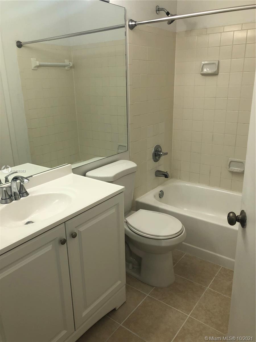 9103 Southwest 138th Place, Unit 9103 Miami, FL 33186 - Photo 12 of 30 a bathroom with a sink a toilet and shower