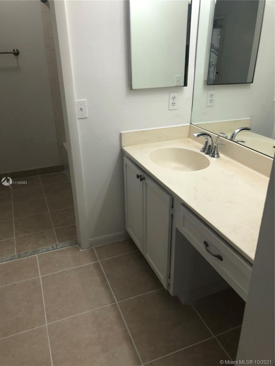 9103 Southwest 138th Place, Unit 9103 Miami, FL 33186 - Photo 13 of 30 a bathroom with a double vanity sink and a mirror
