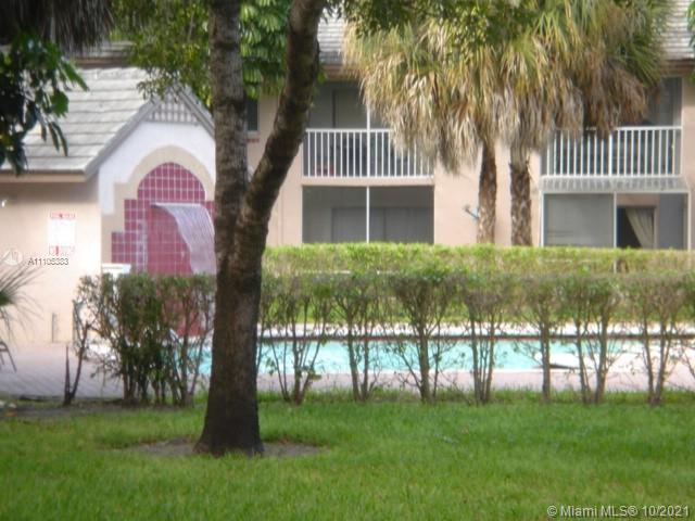 9103 Southwest 138th Place, Unit 9103 Miami, FL 33186 - Photo 18 of 30 a front view of a house with a garden