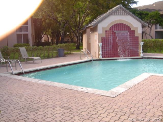 9103 Southwest 138th Place, Unit 9103 Miami, FL 33186 - Photo 19 of 30 a front view of a house with garden