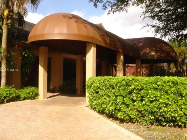 9103 Southwest 138th Place, Unit 9103 Miami, FL 33186 - Photo 20 of 30 a front view of a house with garden