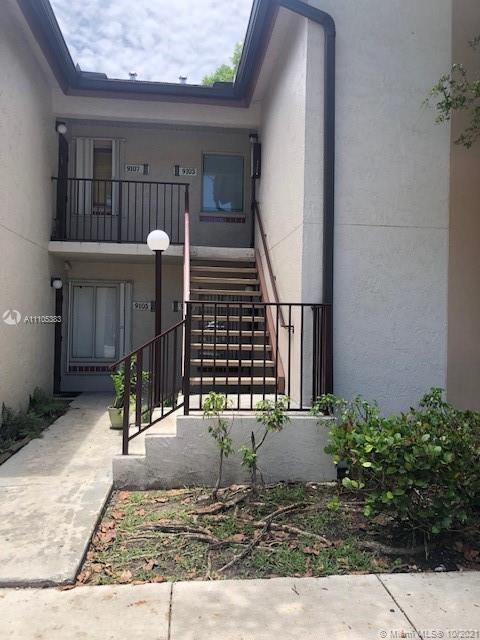 9103 Southwest 138th Place, Unit 9103 Miami, FL 33186 - Photo 3 of 30 a view of a house with a small yard and plants