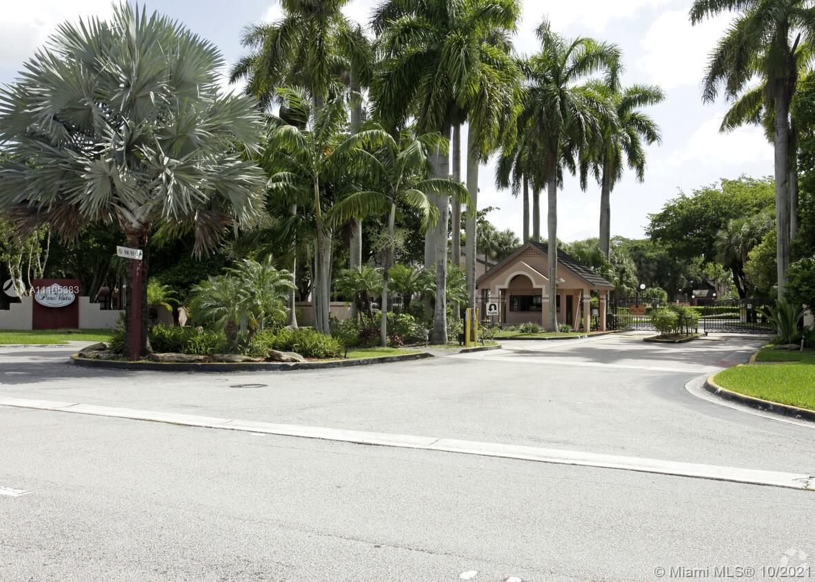 9103 Southwest 138th Place, Unit 9103 Miami, FL 33186 - Photo 21 of 30 a view of a swimming pool with palm trees