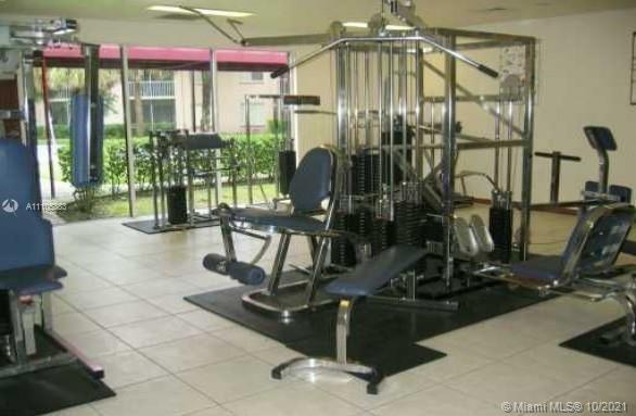 9103 Southwest 138th Place, Unit 9103 Miami, FL 33186 - Photo 23 of 30 a view of a room with gym equipment