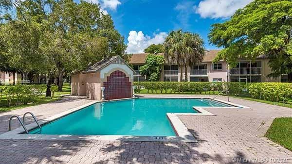9103 Southwest 138th Place, Unit 9103 Miami, FL 33186 - Photo 24 of 30 a front view of a house with garden