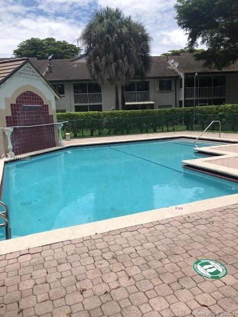 9103 Southwest 138th Place, Unit 9103 Miami, FL 33186 - Photo 25 of 30 a front view of a house with a yard