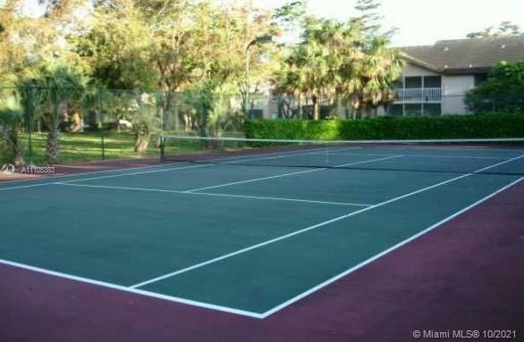 9103 Southwest 138th Place, Unit 9103 Miami, FL 33186 - Photo 26 of 30 a view of a tennis court