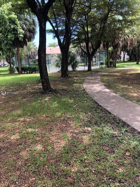 9103 Southwest 138th Place, Unit 9103 Miami, FL 33186 - Photo 28 of 30 a view of a tree in a yard