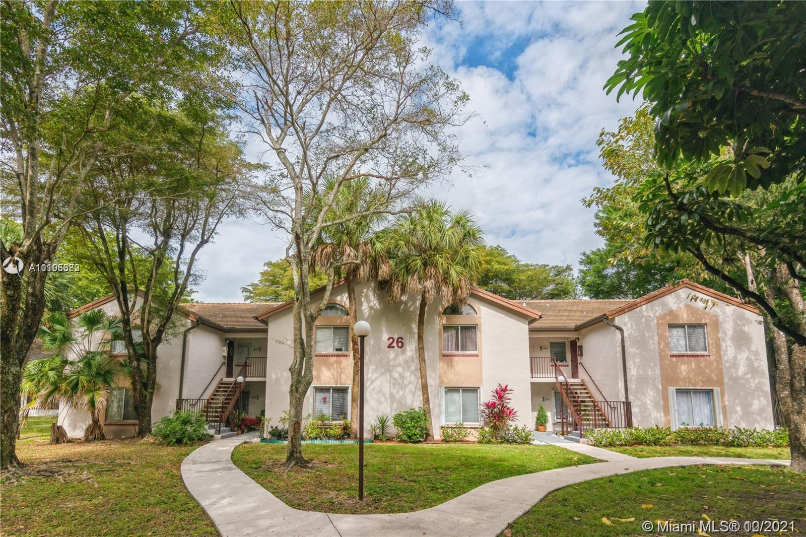 9103 Southwest 138th Place, Unit 9103 Miami, FL 33186 - Photo 30 of 30 a front view of a house with a yard and trees