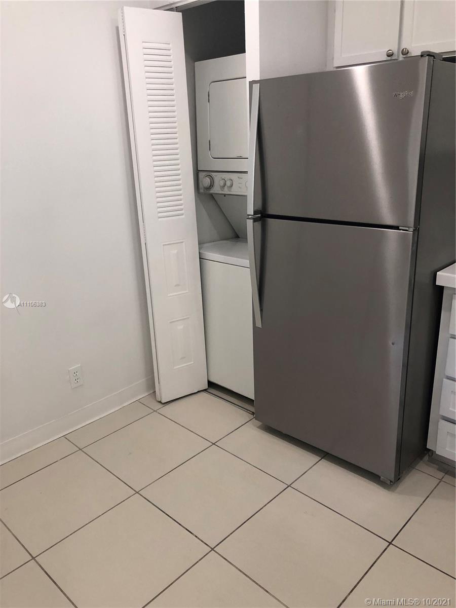 9103 Southwest 138th Place, Unit 9103 Miami, FL 33186 - Photo 7 of 30 a metallic refrigerator freezer sitting in a kitchen