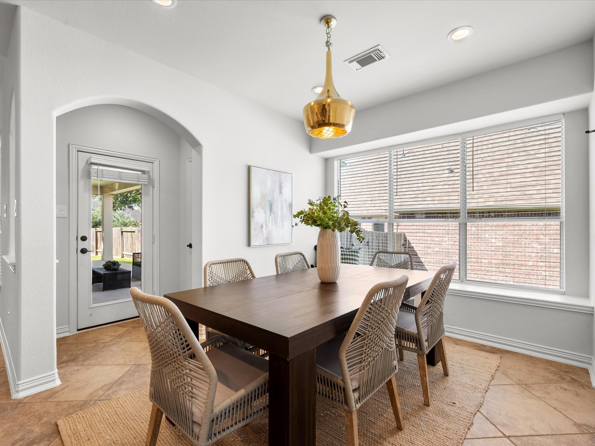 323 Arbor Ridge Lane Conroe, TX 77384 - Photo 13 of 40 Sunday dinners have a home. Bright, roomy, and steps from both the kitchen and the patio. That gold pendant is doing a little something extra and I'm here for it.
