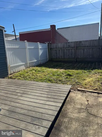 a view of a hallway with wooden floor and closet