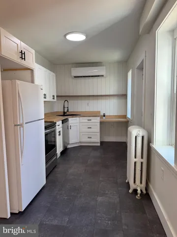 a kitchen with stainless steel appliances a refrigerator a sink a stove top oven