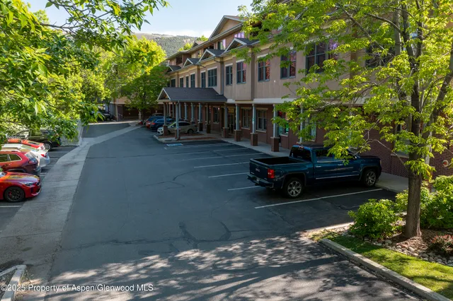 a wooden bench sitting in front of a house