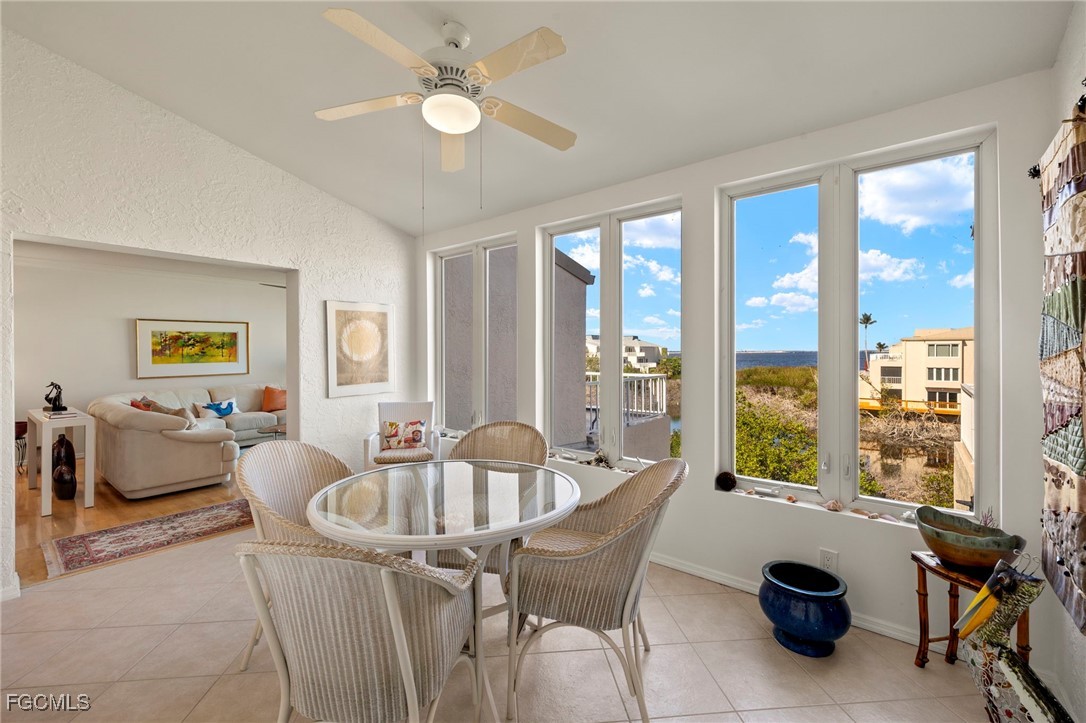 200 Periwinkle Way, Unit 315 Sanibel, FL 33957 - Photo 11 of 33 a dining room with furniture and a floor to ceiling window
