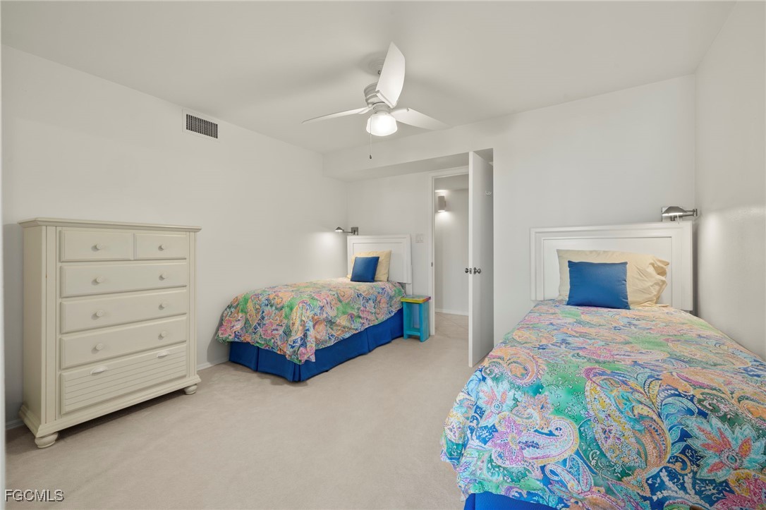 200 Periwinkle Way, Unit 315 Sanibel, FL 33957 - Photo 21 of 33 a bedroom with a bed and a chandelier