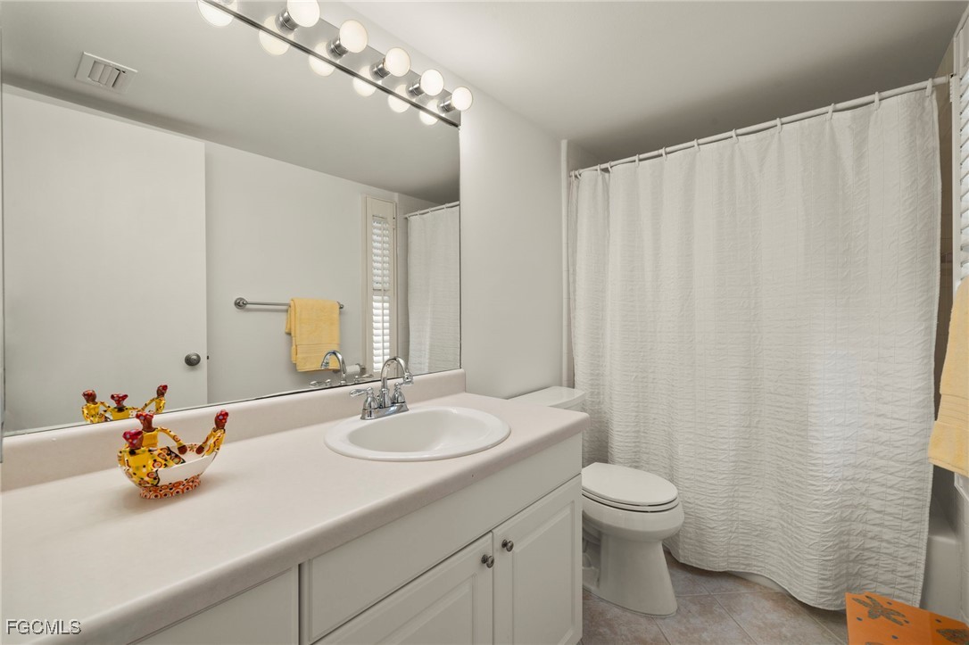 200 Periwinkle Way, Unit 315 Sanibel, FL 33957 - Photo 22 of 33 a bathroom with a sink a toilet and a mirror