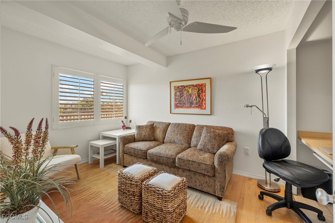 200 Periwinkle Way, Unit 315 Sanibel, FL 33957 - Photo 23 of 33 a living room with furniture and a large window