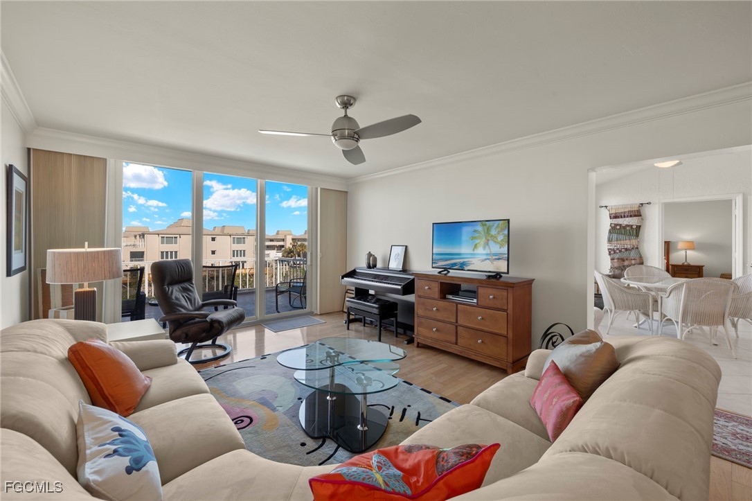 200 Periwinkle Way, Unit 315 Sanibel, FL 33957 - Photo 10 of 33 a living room with furniture kitchen view and a large window