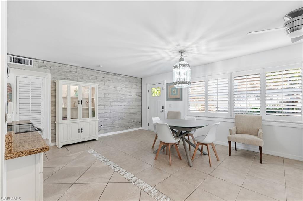 604 110th Avenue North Naples, FL 34108 - Photo 10 of 41 a dining room with furniture and window