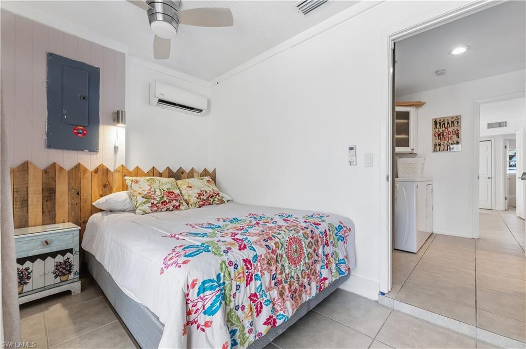 604 110th Avenue North Naples, FL 34108 - Photo 14 of 41 a bedroom with a bed and a view of bathroom