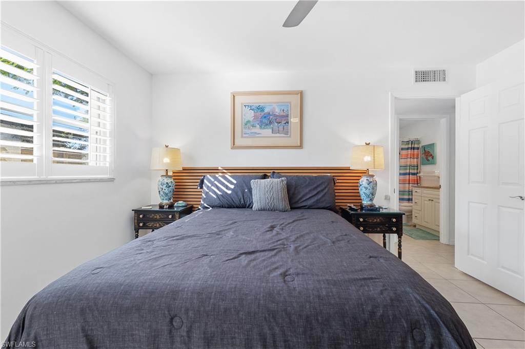 604 110th Avenue North Naples, FL 34108 - Photo 16 of 41 a bedroom with bed and window