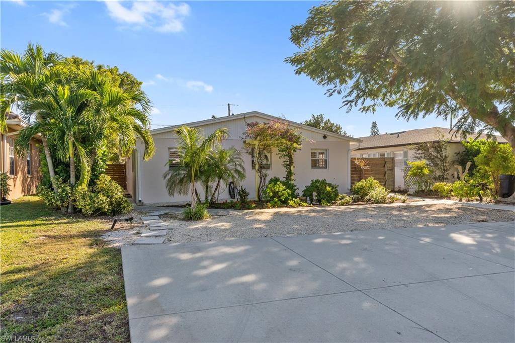604 110th Avenue North Naples, FL 34108 - Photo 2 of 41 a view of a street with a building in front of it