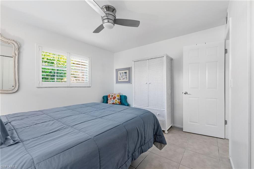 604 110th Avenue North Naples, FL 34108 - Photo 22 of 41 a bedroom with a bed and a window