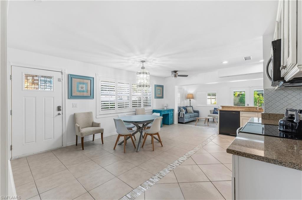604 110th Avenue North Naples, FL 34108 - Photo 23 of 41 a group of chairs sitting in kitchen and dining room