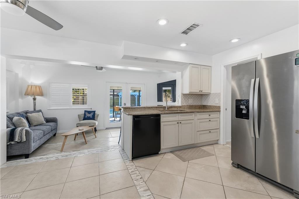604 110th Avenue North Naples, FL 34108 - Photo 41 of 41 a large kitchen with stainless steel appliances granite countertop a refrigerator and a stove top oven