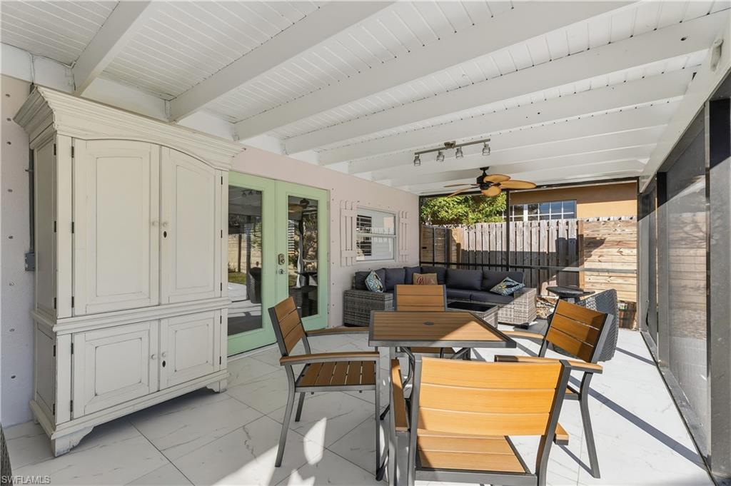 604 110th Avenue North Naples, FL 34108 - Photo 24 of 41 a living room with furniture a fireplace and a chandelier