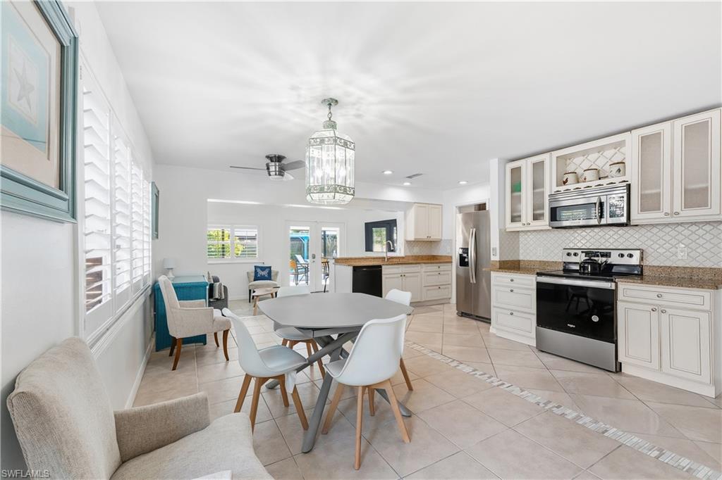 604 110th Avenue North Naples, FL 34108 - Photo 6 of 41 a view of a dining room kitchen and a window